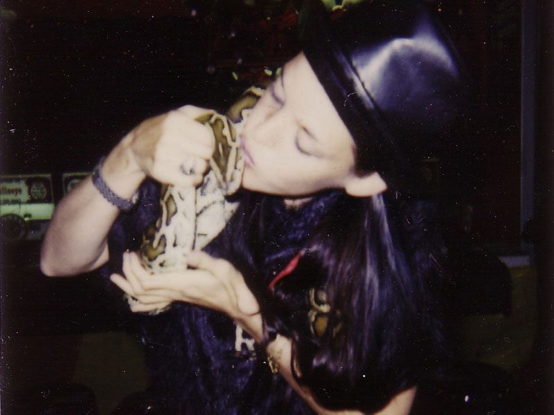 Romy Ashby kissing a snake